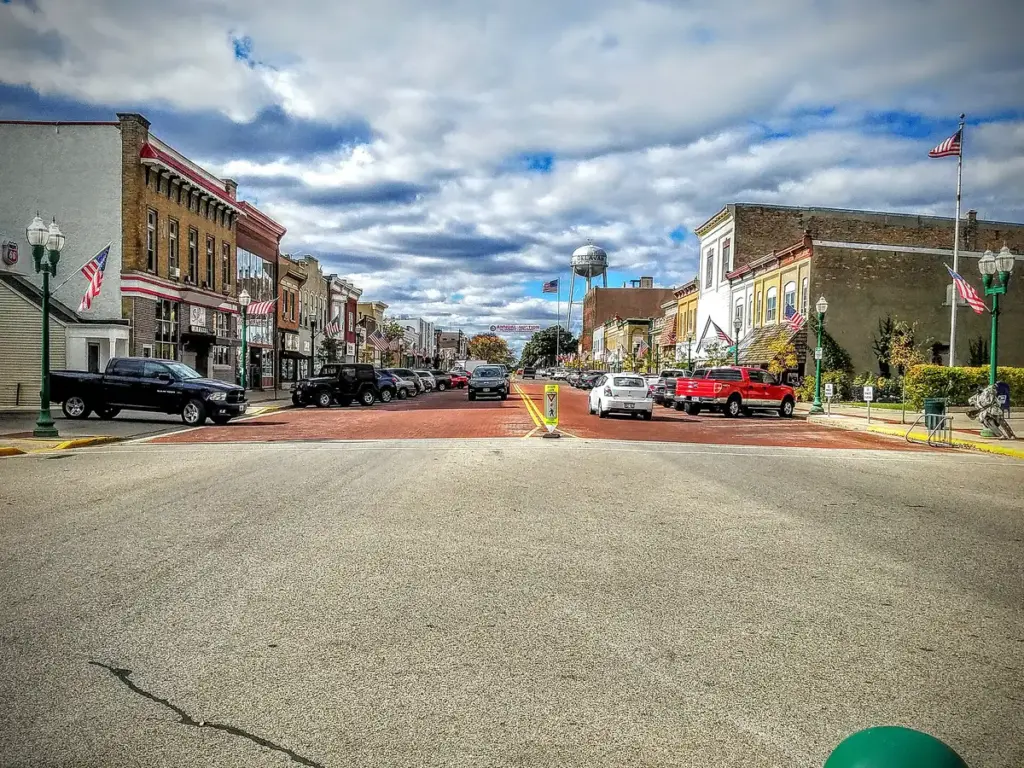 Downtown Delavan: brick storefronts, flags and a water tower along the main street