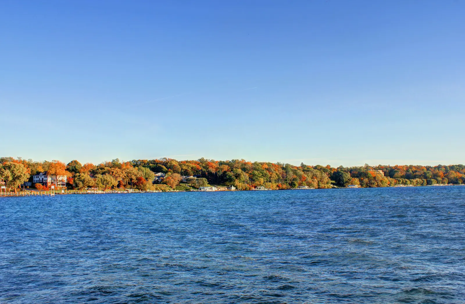 Geneva Lake in Lake Geneva, Wisconsin: autumn trees and lakeside homes along the far shore