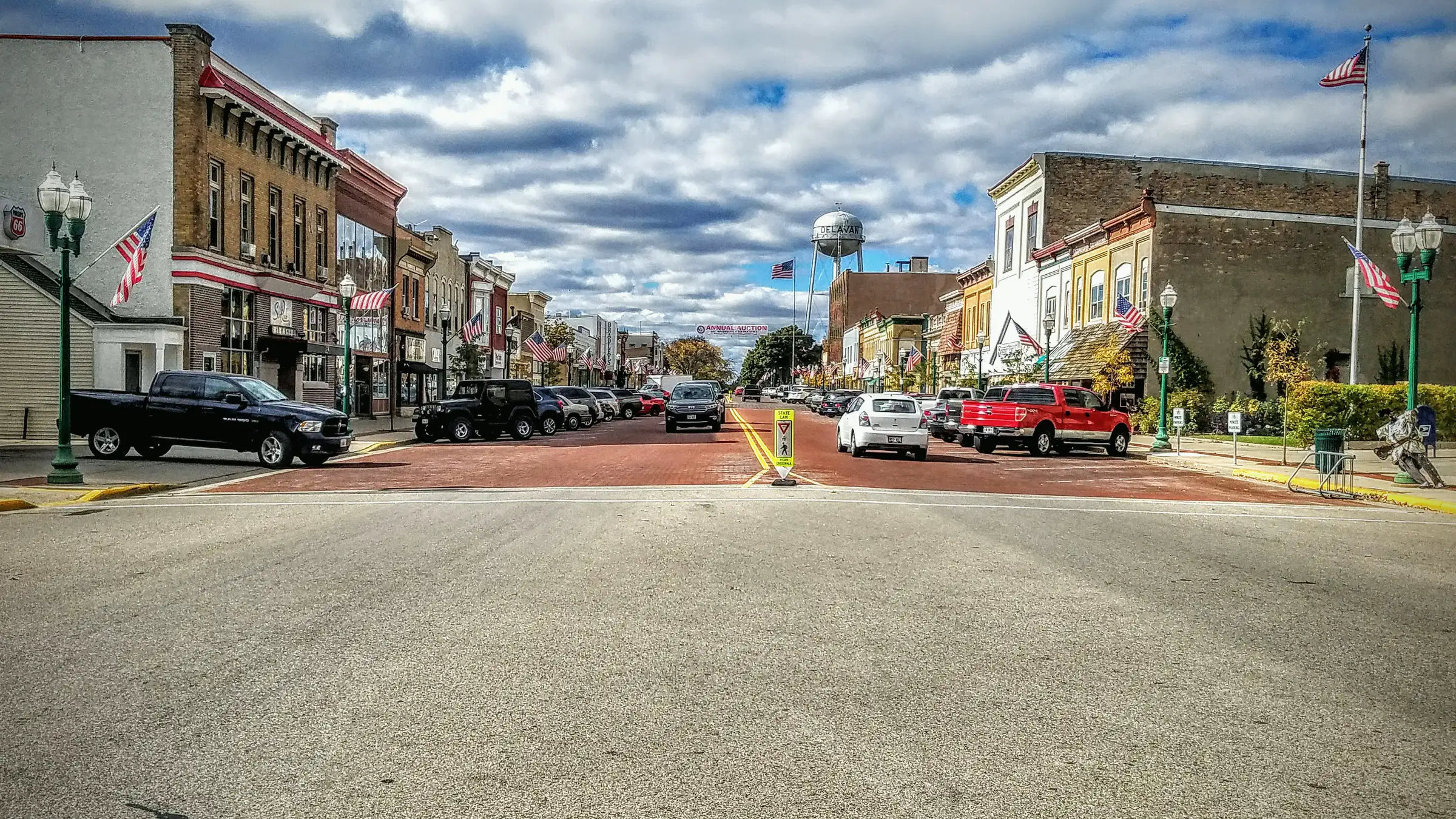 Downtown Delavan, Wisconsin: brick storefronts, flags and the water tower along the main street